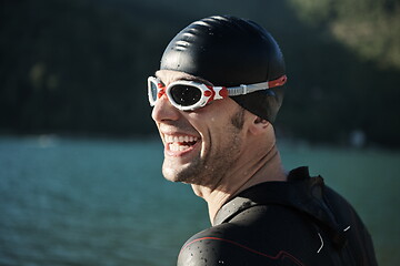 Image showing triathlon athlete starting swimming training on lake