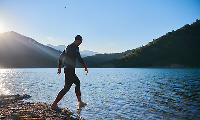 Image showing triathlon athlete starting swimming training on lake