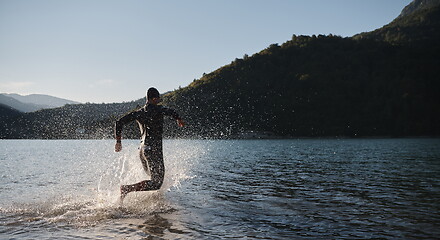 Image showing triathlon athlete starting swimming training on lake