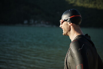 Image showing triathlon athlete starting swimming training on lake