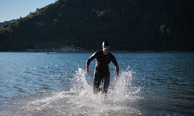 Image showing triathlon athlete starting swimming training on lake