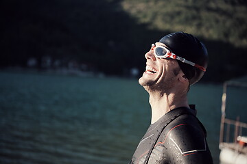 Image showing triathlon athlete starting swimming training on lake