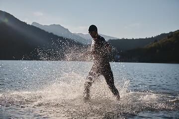 Image showing triathlon athlete starting swimming training on lake