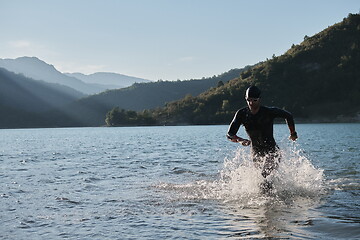 Image showing triathlon athlete starting swimming training on lake