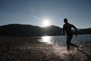 Image showing triathlon athlete starting swimming training on lake