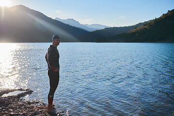 Image showing triathlon athlete starting swimming training on lake