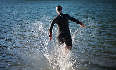 Image showing triathlon athlete starting swimming training on lake