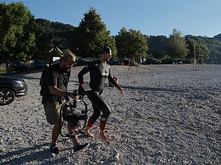 Image showing videographer taking action shot of triathlon swimming athlete