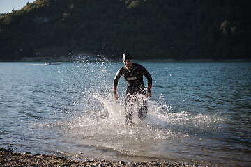 Image showing triathlon athlete starting swimming training on lake