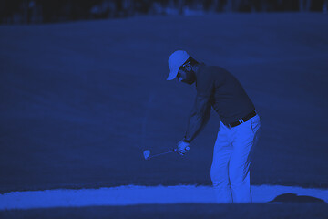 Image showing golfer hitting a sand bunker shot