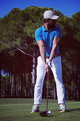 Image showing golf player hitting shot