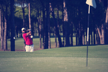 Image showing golfer hitting a sand bunker shot