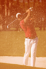 Image showing golfer hitting a sand bunker shot