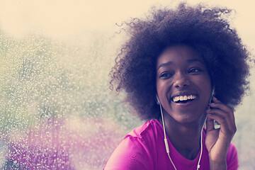 Image showing portrait of young afro american woman in gym while listening mus