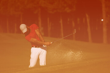 Image showing golfer hitting a sand bunker shot