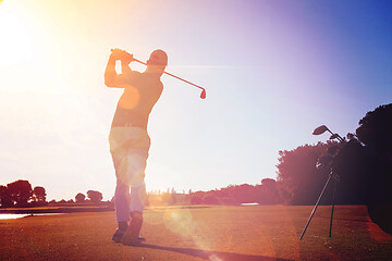 Image showing golf player hitting shot with club