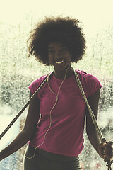 Image showing portrait of young afro american woman in gym while listening mus