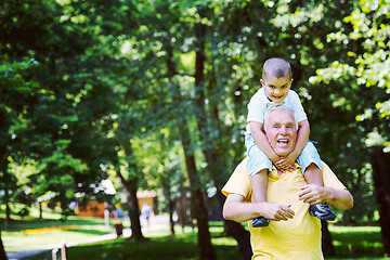 Image showing grandfather and child have fun  in park