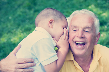 Image showing grandfather and child have fun  in park