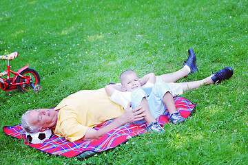 Image showing grandfather and child in park using tablet