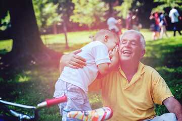 Image showing grandfather and child have fun  in park