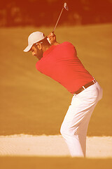 Image showing golfer hitting a sand bunker shot