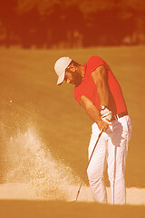 Image showing golfer hitting a sand bunker shot