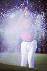 Image showing golfer hitting a sand bunker shot