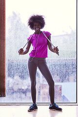 Image showing portrait of young afro american woman in gym while listening mus