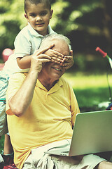 Image showing grandfather and child using laptop