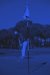 Image showing golf player hitting shot at sunny day