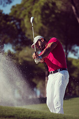 Image showing golfer hitting a sand bunker shot