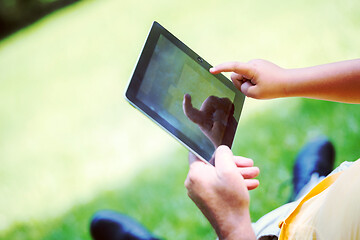 Image showing grandfather and child in park using tablet