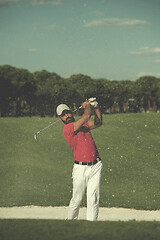 Image showing golfer hitting a sand bunker shot