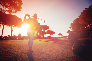 Image showing golf player hitting shot with club