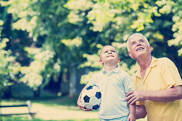 Image showing grandfather and child have fun  in park