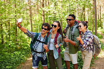 Image showing friends with backpacks hiking and taking selfie