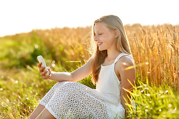 Image showing happy young girl taking selfie by smartphone