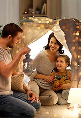 Image showing happy family playing in kids tent at night at home