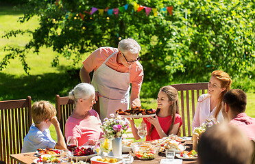 Image showing happy family having dinner or summer garden party