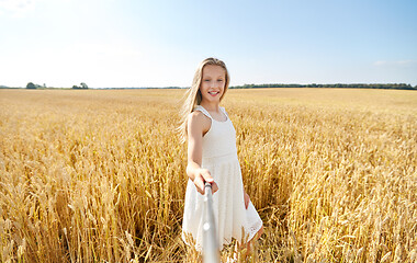 Image showing happy girl taking selfie on cereal field