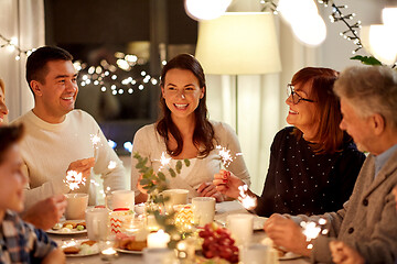 Image showing family with sparklers having tea party at home