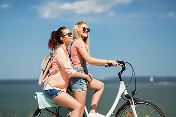 Image showing teenage girls or friends riding bicycle in summer