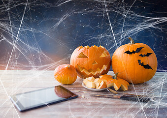 Image showing halloween jack-o-lantern, pumpkins and tablet pc