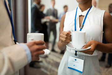 Image showing business people with conference badges and coffee