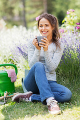 Image showing woman drinking tea or coffee at summer garden