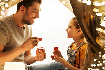 Image showing family playing tea party in kids tent at home