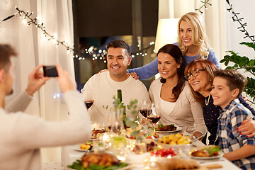 Image showing family having dinner party and taking selfie