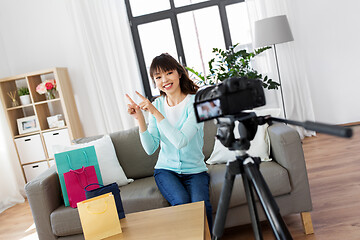 Image showing female blogger making video blog about shopping