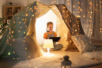 Image showing little girl with tablet pc in kids tent at home